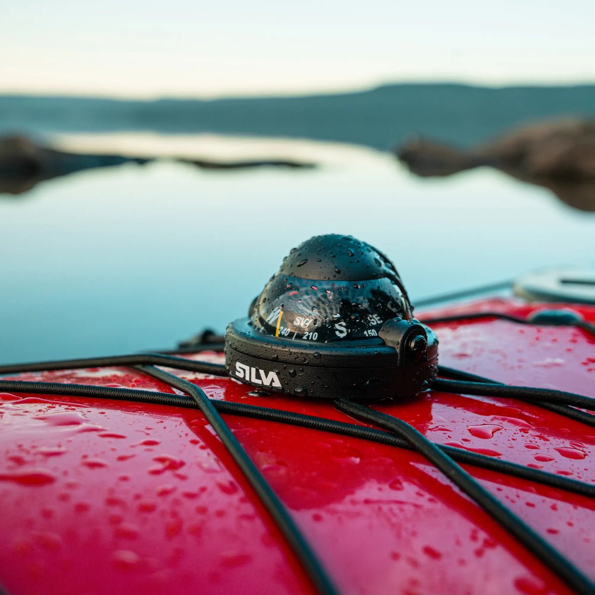 Silva 58 kayak compass attached to deck lines on a red sea kayak