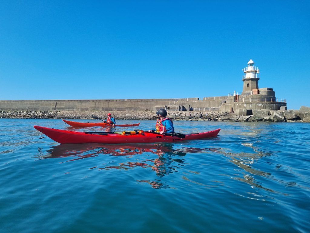 Sea kayakers paddling together on the Pembrokeshire coast
